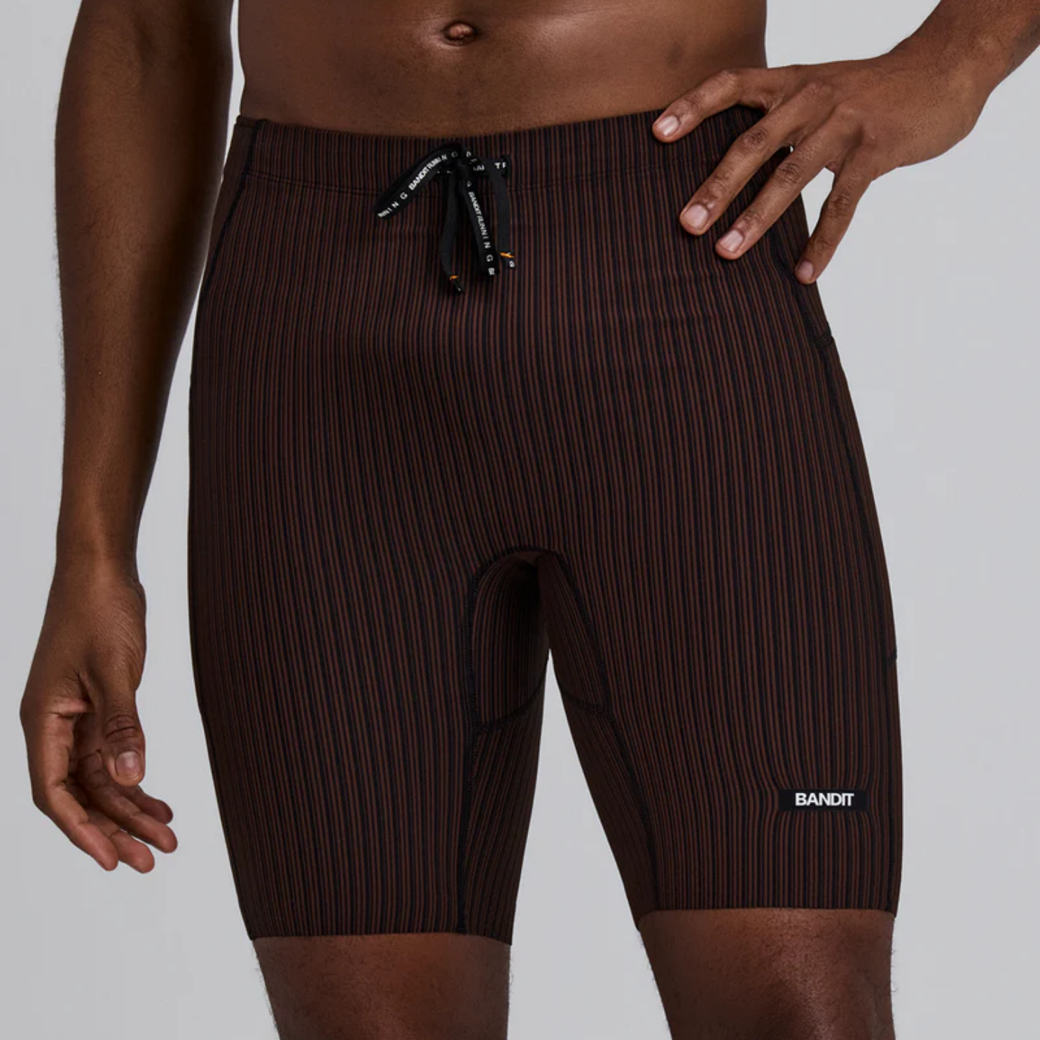 Bandit Running Striped Cadence™ 7 Pocket Lined Half Tights - Cacao/Black